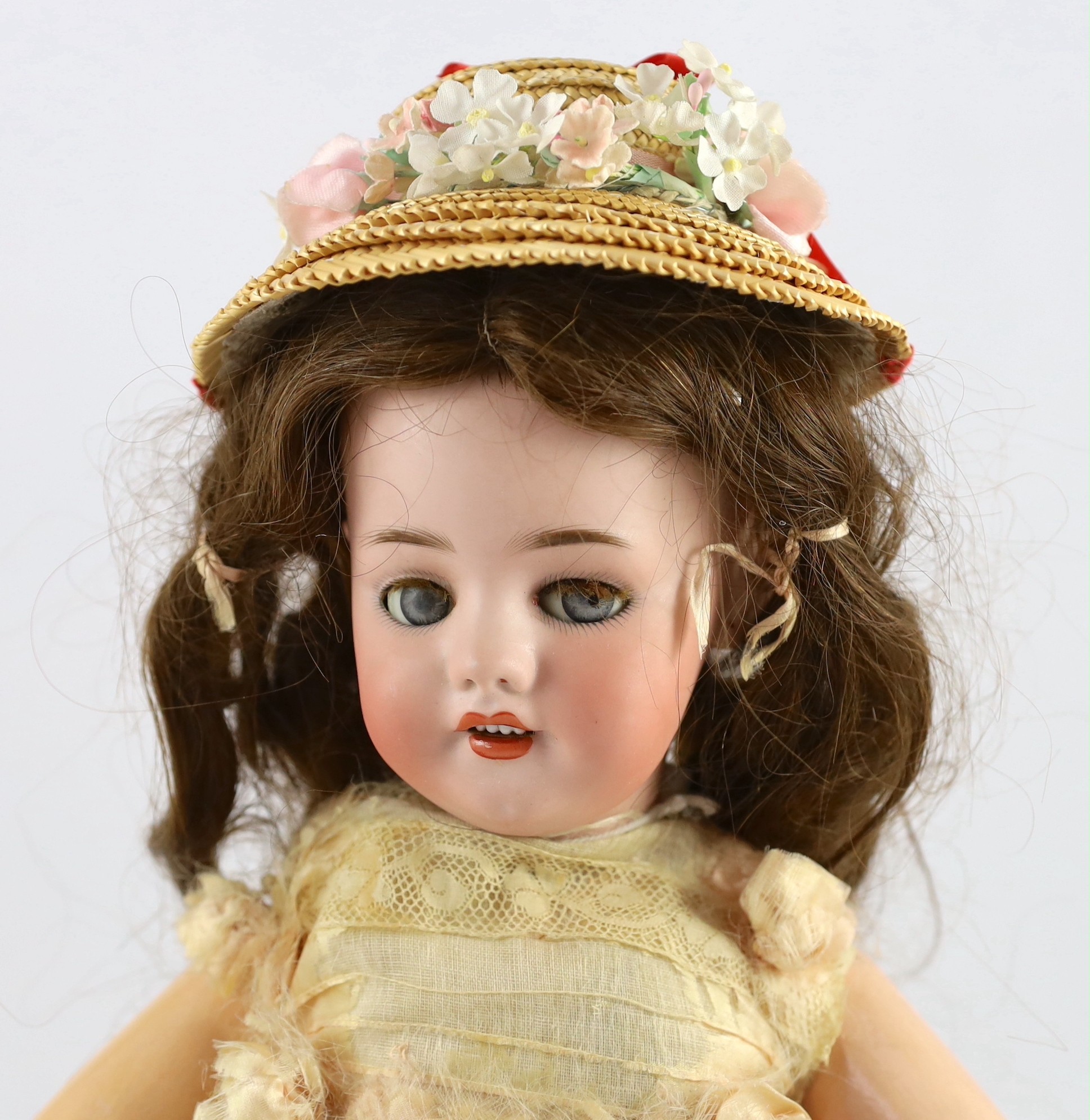 A rare Simon & Halbig walking kiss-blowing bisque doll, German, circa 1891, 22in.